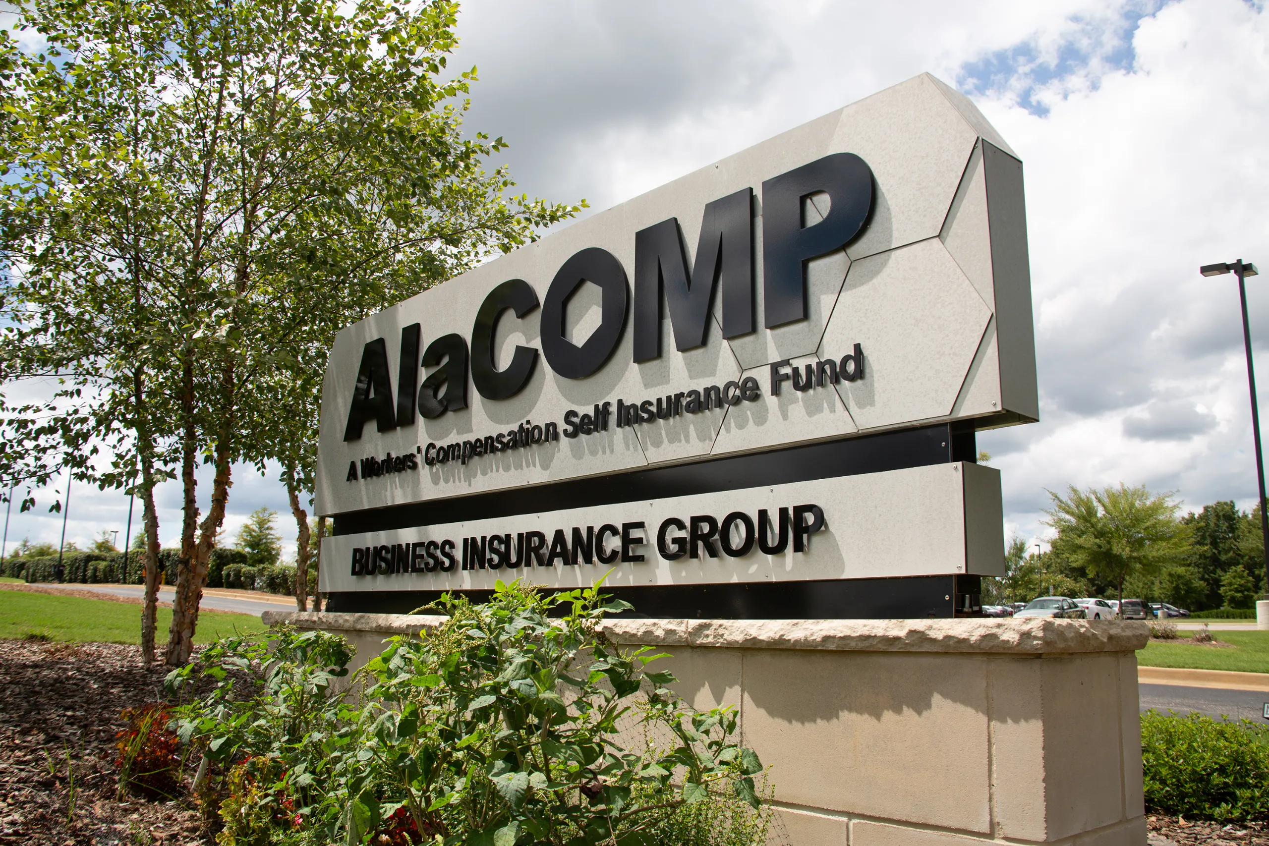 AlaCOMP team members meeting in a glass-walled conference room.