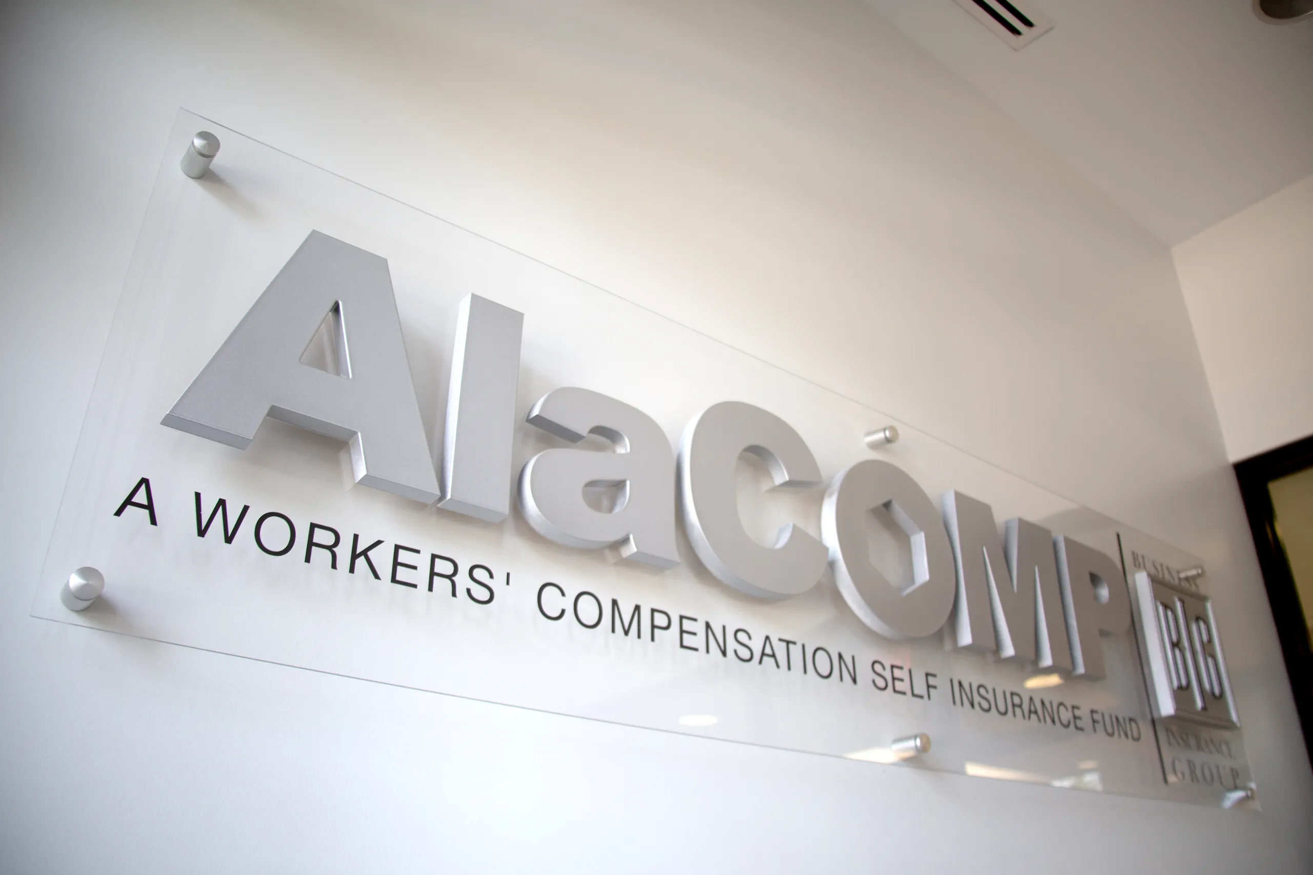 AlaCOMP team members meeting in a glass-walled conference room.